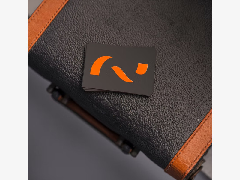 MadLow Studio business card's abstract orange logo on a black background