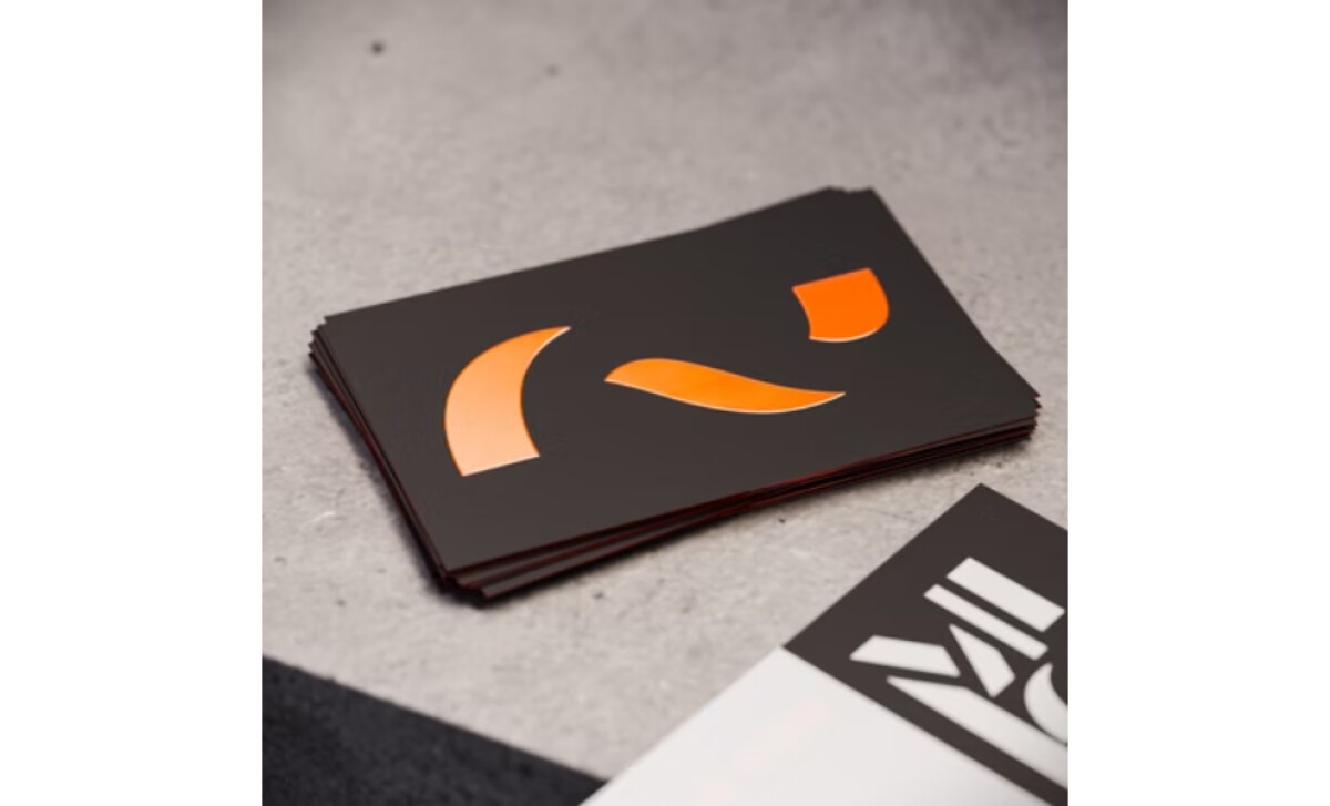 A stack of MadLow Studio business cards