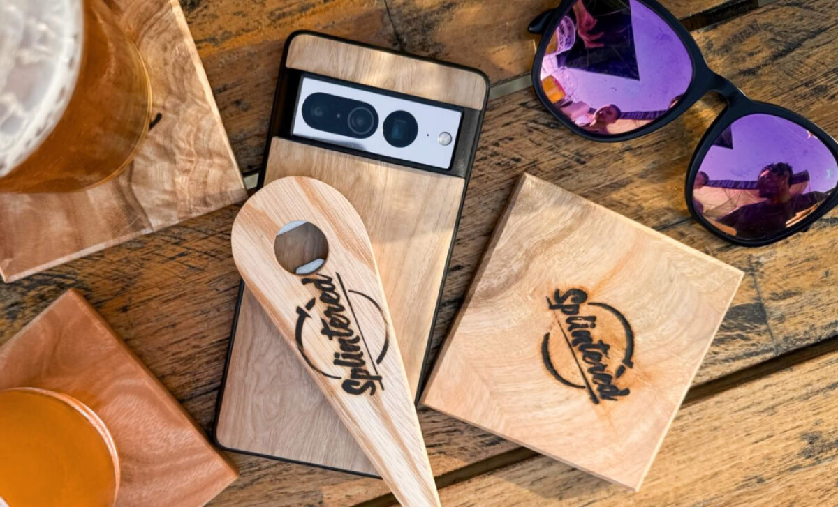 Flat-lay image showing wooden merchandise branded with the Splintered logo by Rewired Graphics.