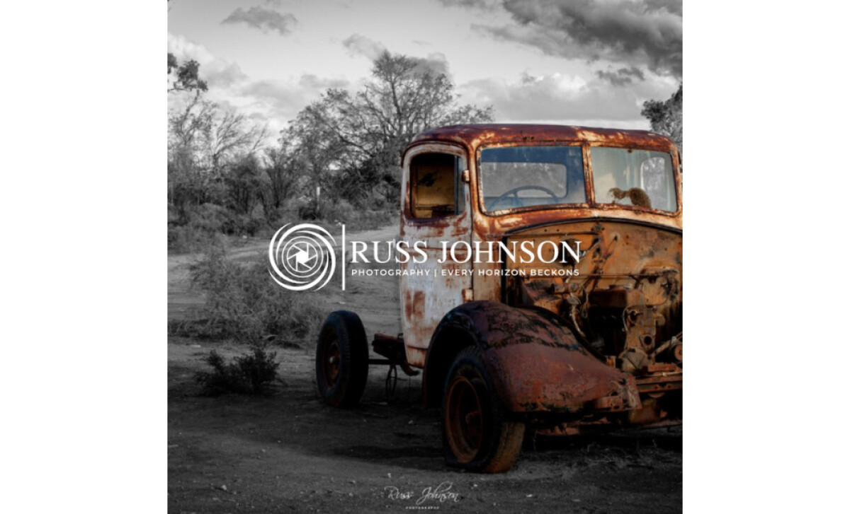 Rusted truck in a dry landscape with the Russ Johnson Photography logo overlayed by Hey! It's Lola.