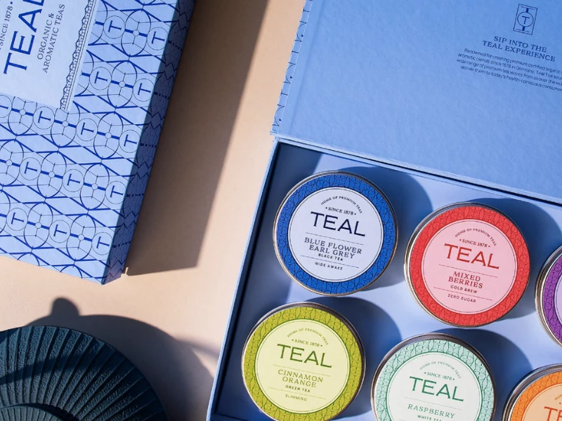 Teal Tea gift box with colorful tins by Unkoated.