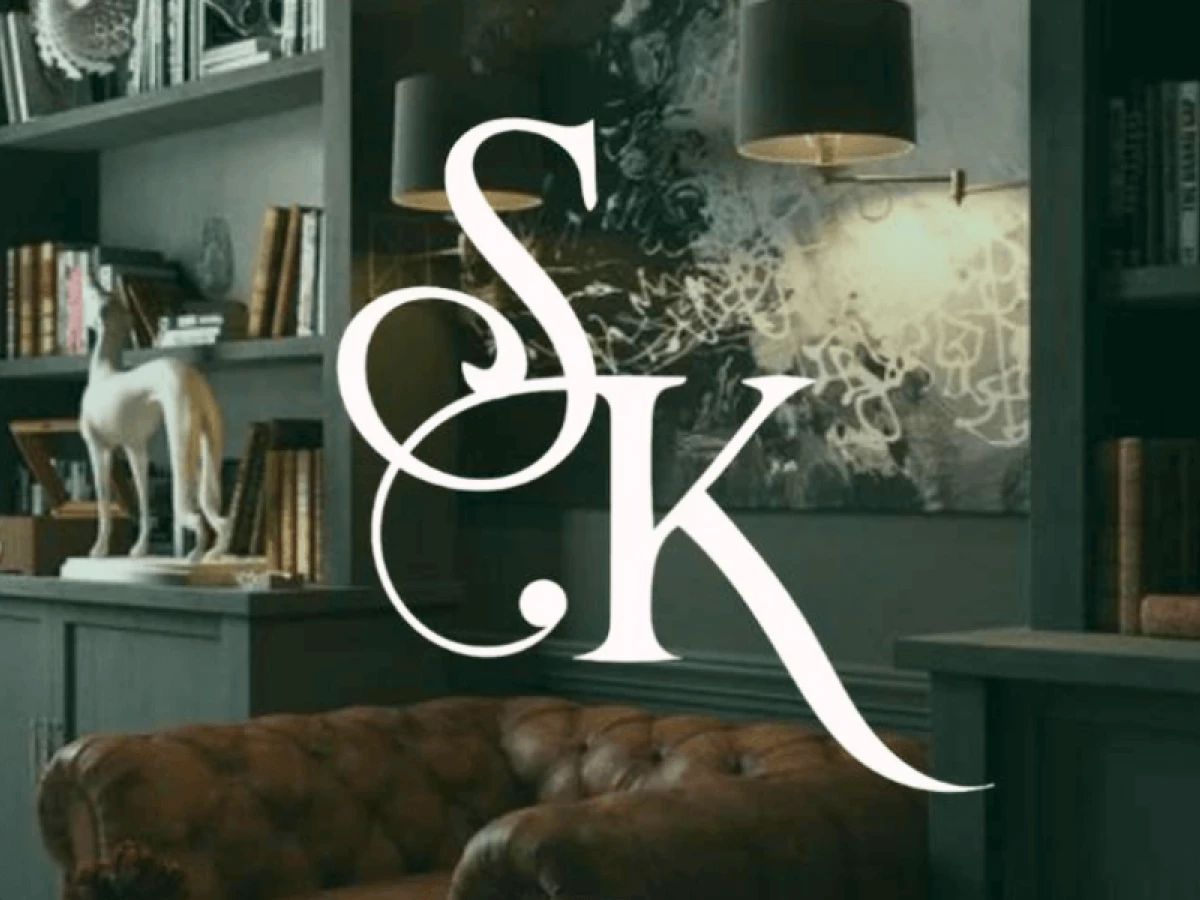 SK monogram logo in elegant serif font over library interior background
