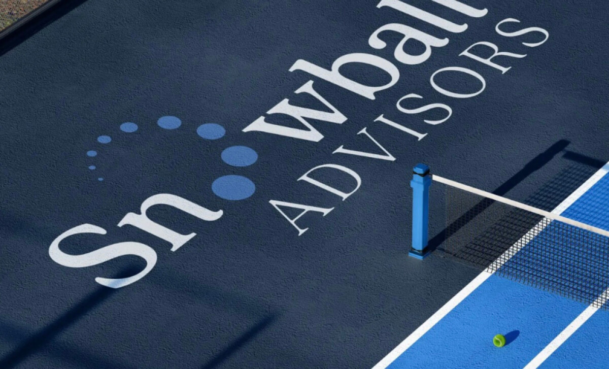 Snowball Advisors logo with blue dot arc painted on outdoor court.