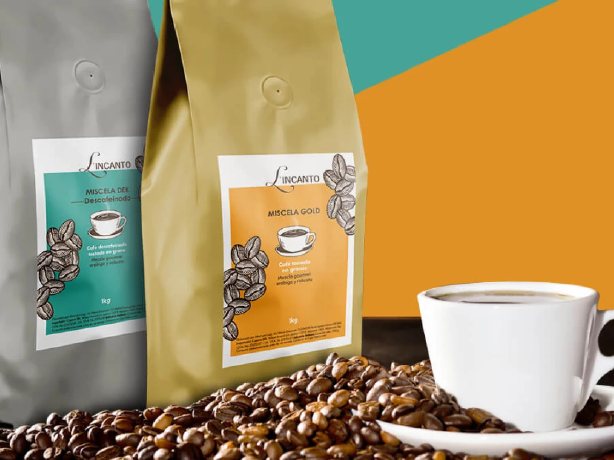 Coffee packaging of L’Incanto Miscela Gold and Miscela Dek with cup of coffee and beans.