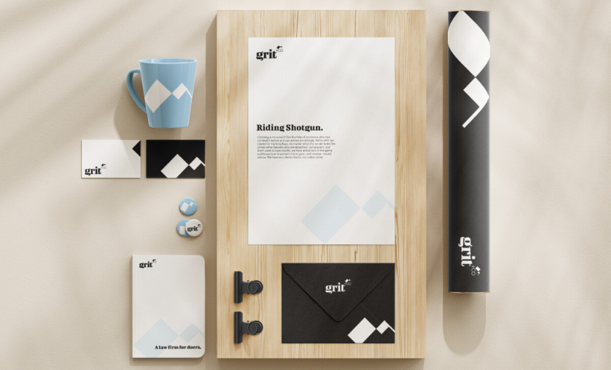 Branded stationery and merchandise featuring Grit +CO logo