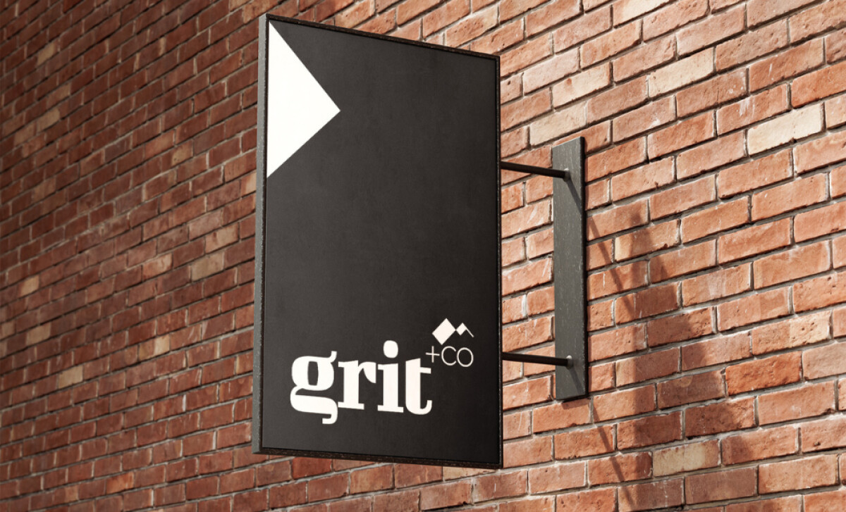 Black outdoor sign with Grit +CO logo and geometric mark