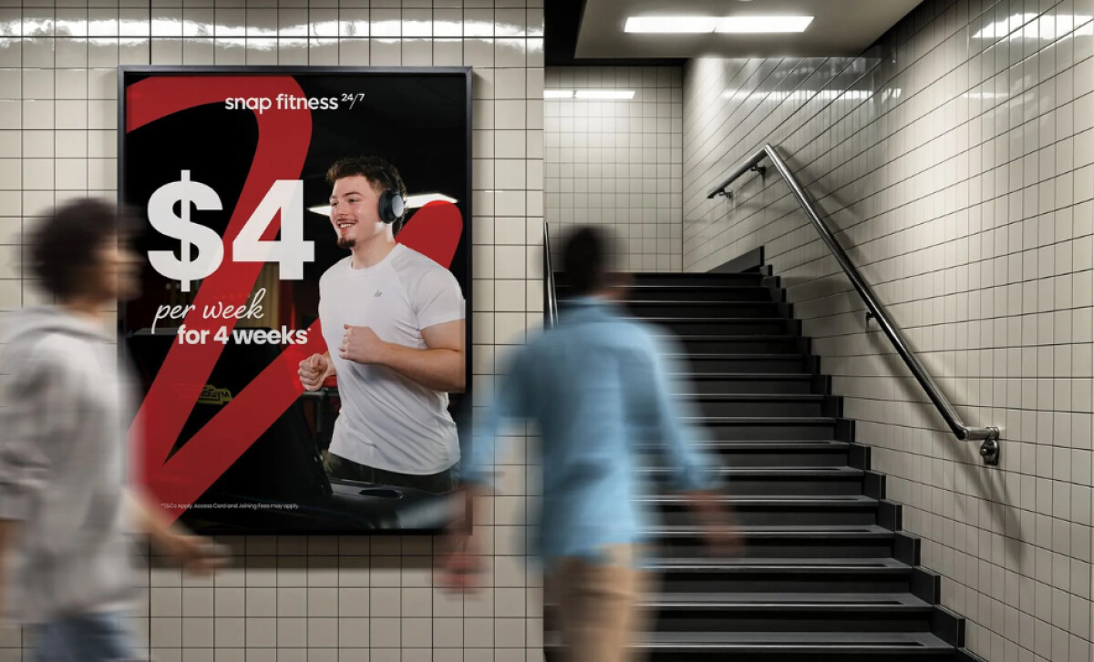 Snap Fitness poster advertisement mounted on a tiled wall by GAZE Creative.