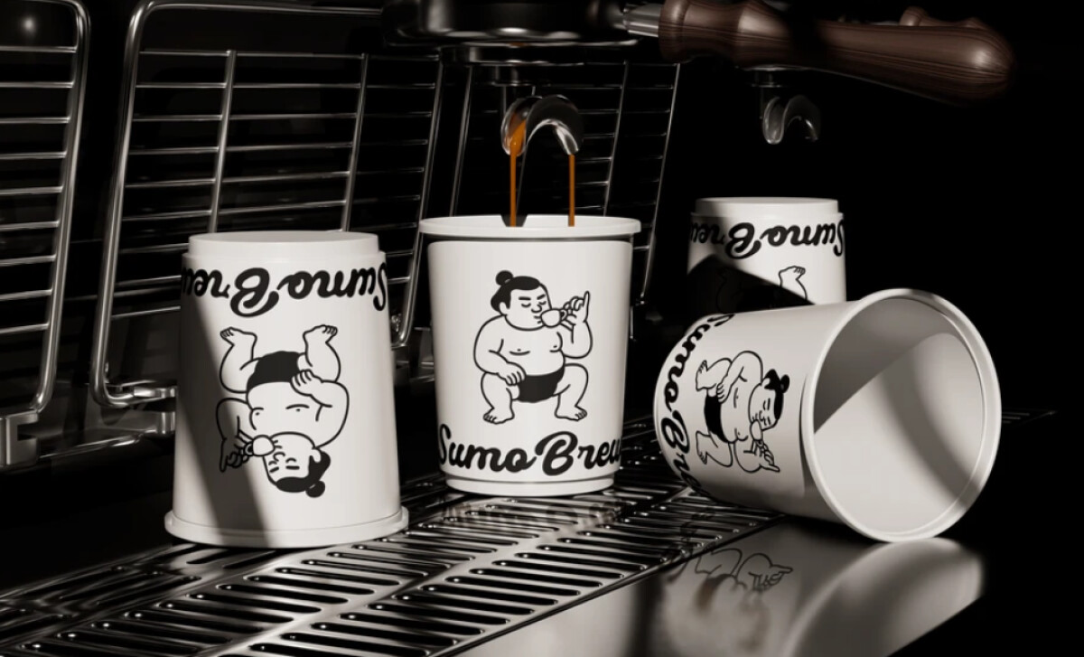 A person's hand holding a white Sumo Brew coffee cup by Attlas Design.