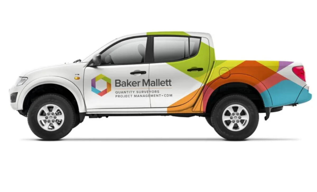 White pickup truck with Baker Mallett branding by AS Partners.