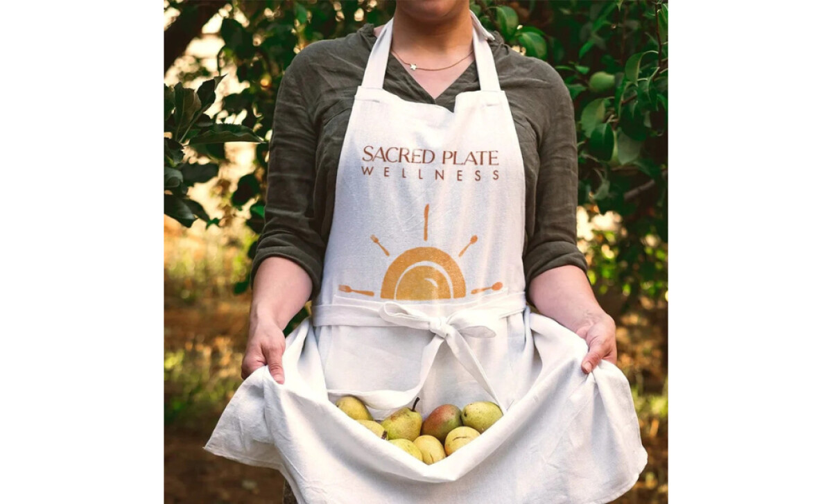 Sacred Plate Wellness logo on print