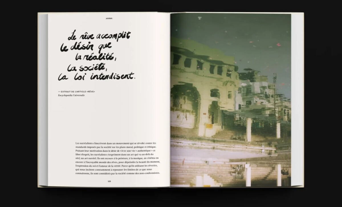 Anima book spread with a calligraphic French quote and a photo of a building's reflection by Mocci Studio.
