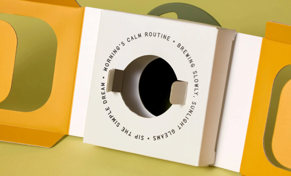 A close-up view of the base of the Dwell Dripper's white packaging, showing printed text by Zenpack.