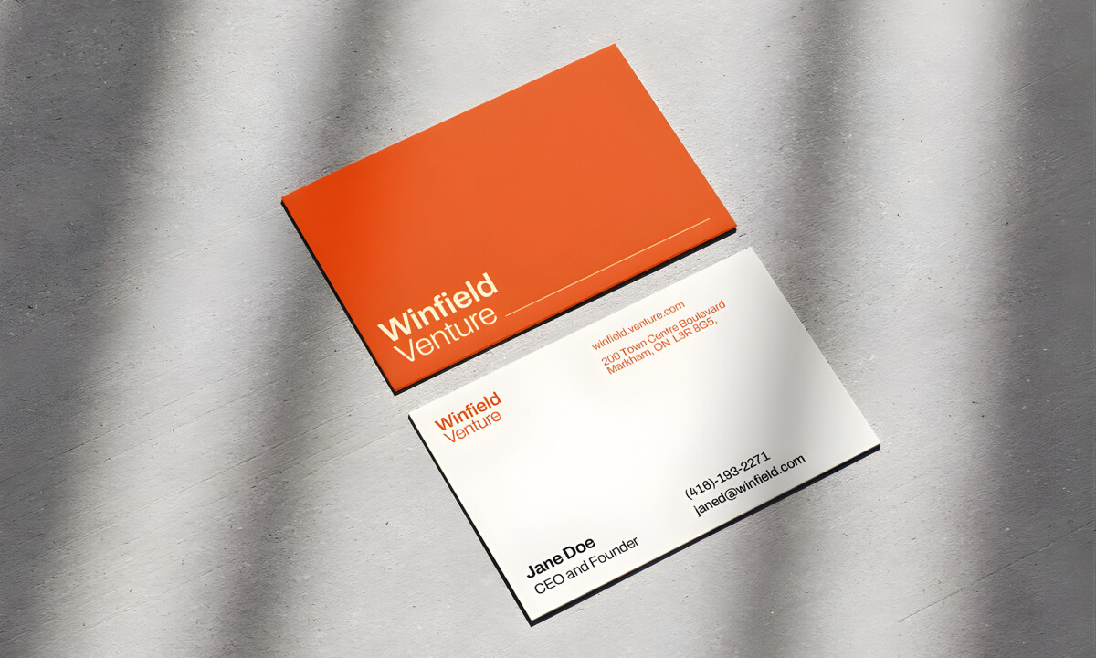 Orange and white business cards with clean, modern typography