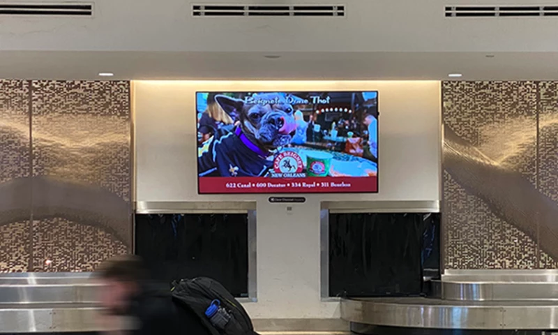 Café Beignet baggage claim digital advertisement