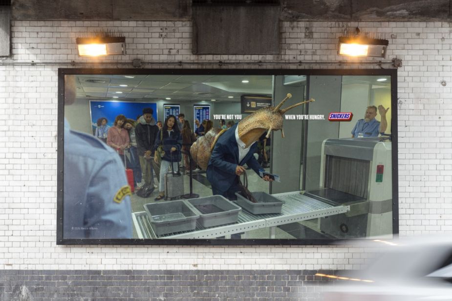 Snickers New Campaign A man with a snail face at the airport