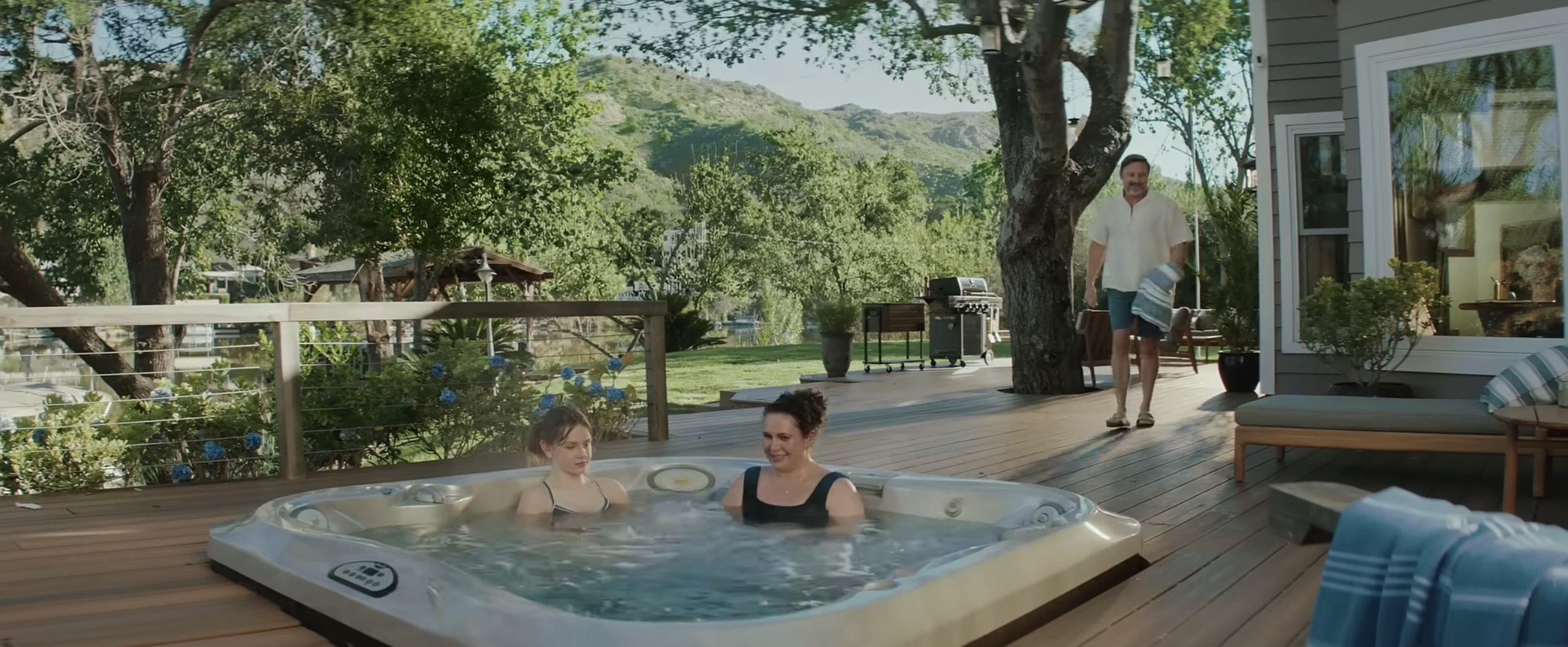 A young woman in the hot tub with her mother in the "Teen" spot | Source: Vrbo