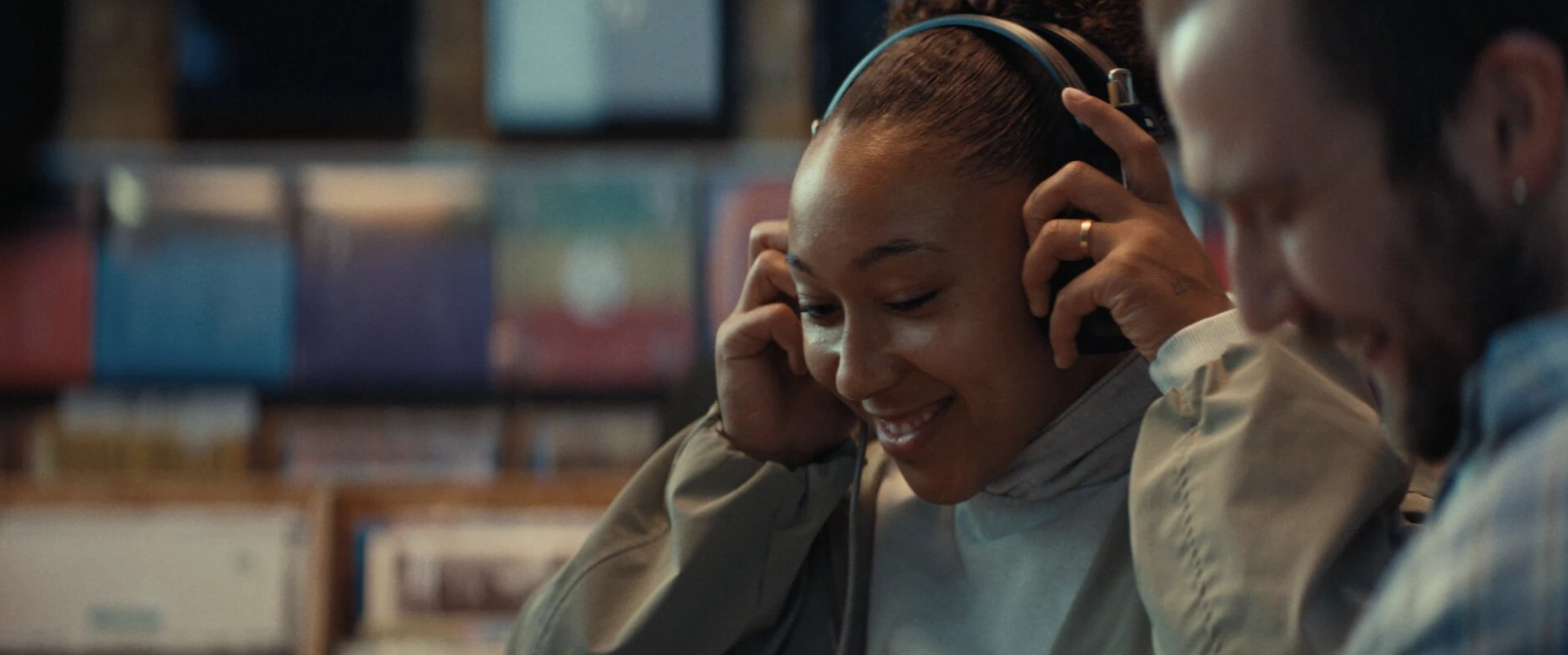 Lauren James accompanying a woman browse records in the "Win for Your Squad" spot | Source: Cadbury
