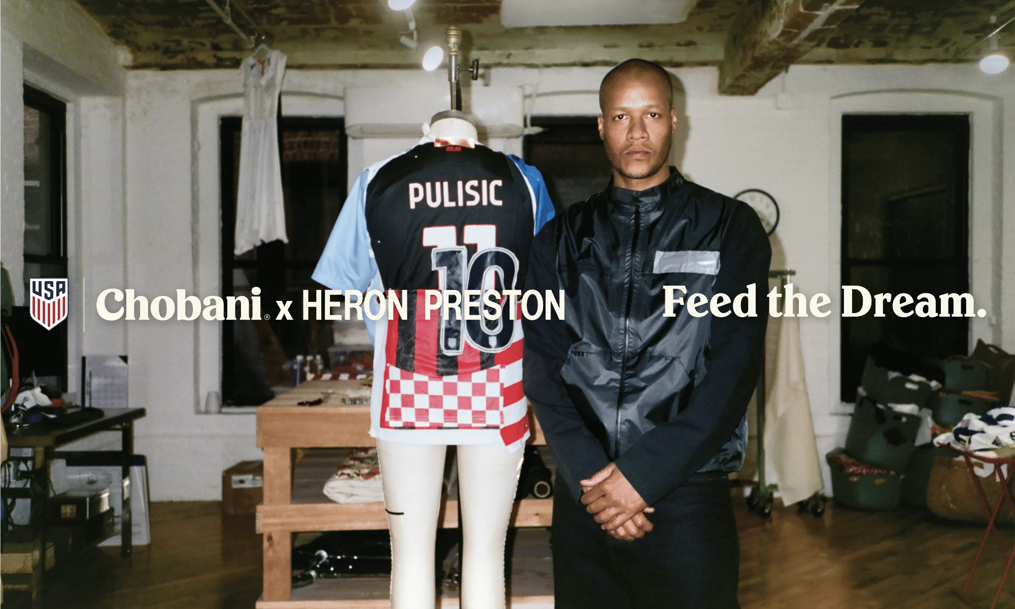 Heron Preston stands beside a custom Pulisic shirt in a campaign workshop setting.