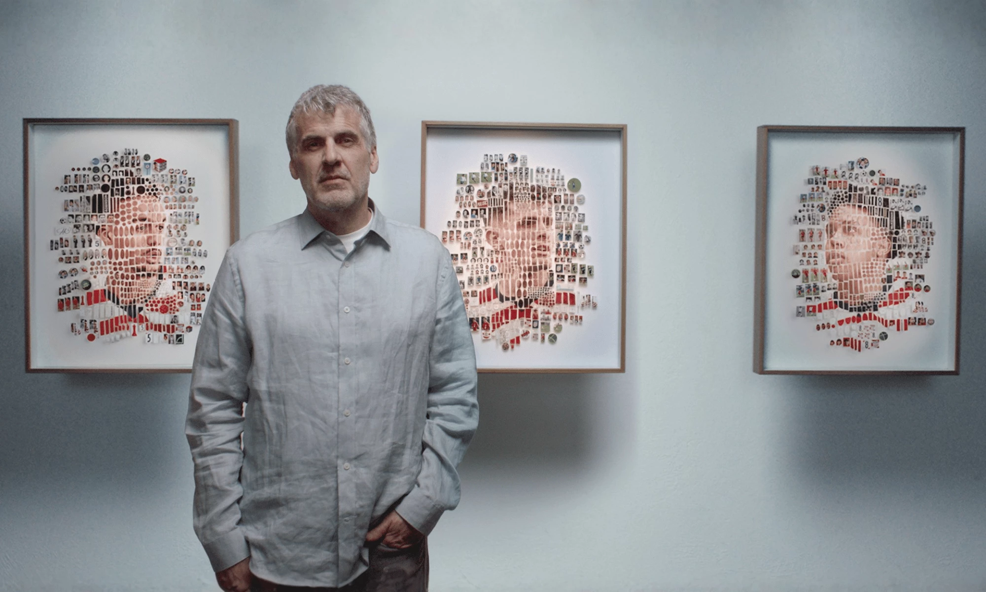 Michael Mapes stands beside framed collage portraits created for the Feed the Dream campaign.