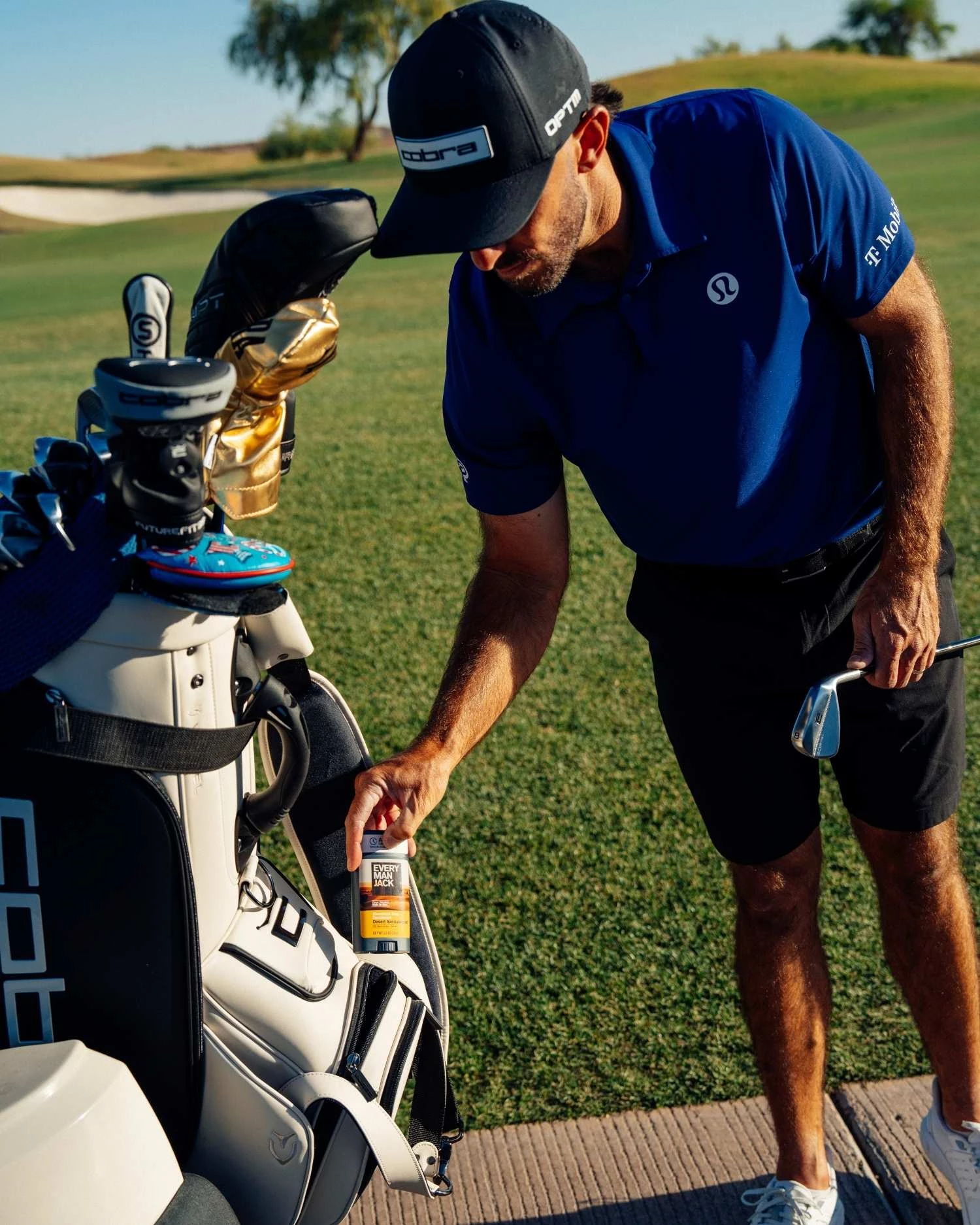 max-homa-emj-on-the-golf-course Max Homa placing an Every Man Jack product in his golf bag.