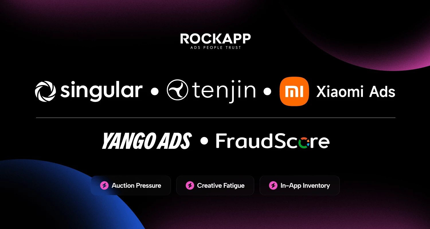 An informational graphic for "ROCKAPP_Business_Of_Apps.png" set against a dark background with subtle blue and pink gradient accents. The Rockapp logo sits at the top center. Below it, a horizontal row displays the company logos for Singular, Tenjin, and Xiaomi Ads. A second row features the logos for Yango Ads and FraudScore. At the bottom, three dark buttons with pink lightning bolt icons list key industry topics: "Auction Pressure," "Creative Fatigue," and "In-App Inventory."