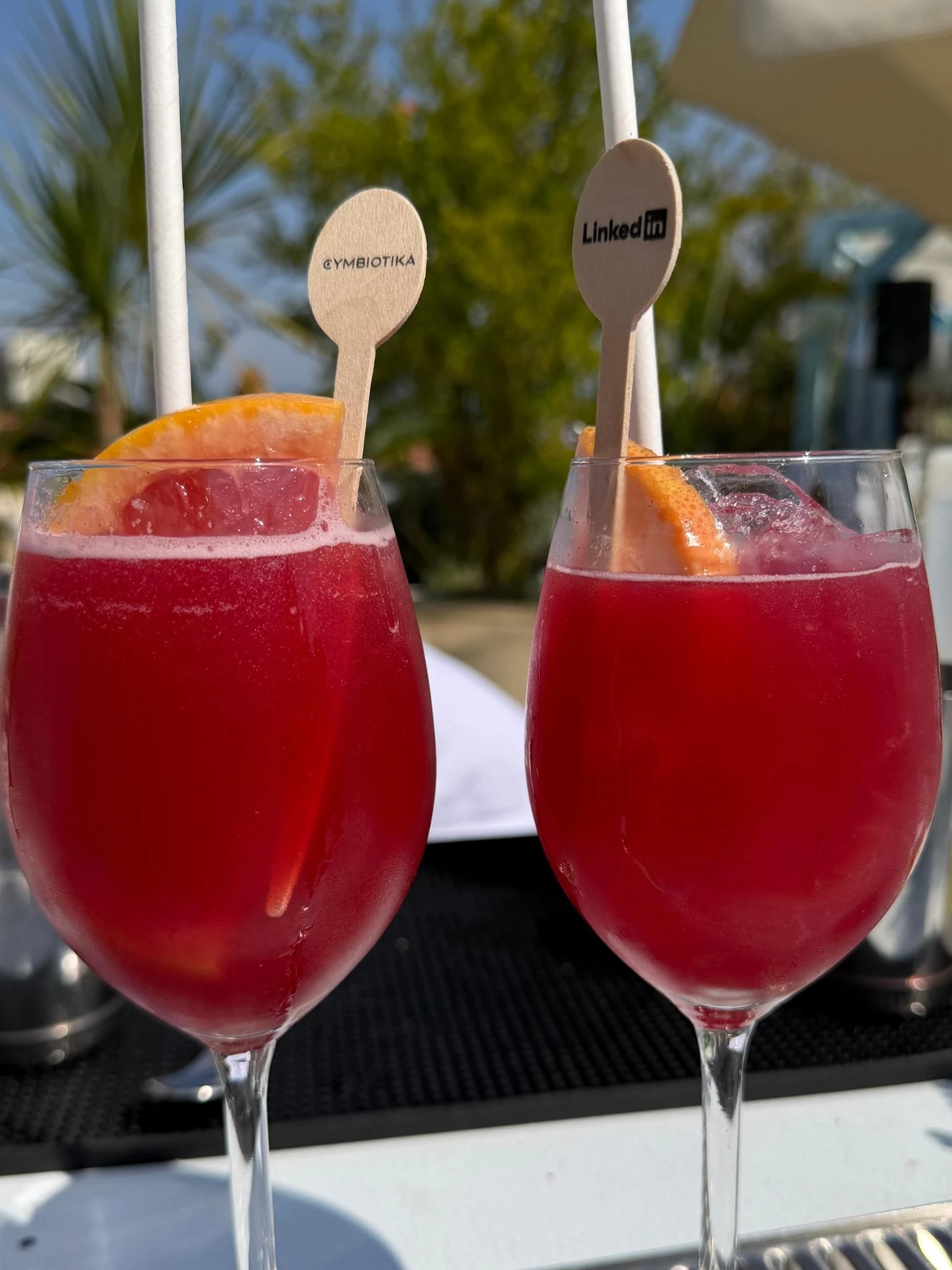 Mocktails with Cymbiotika and LinkedIn branded wooden stirrers.