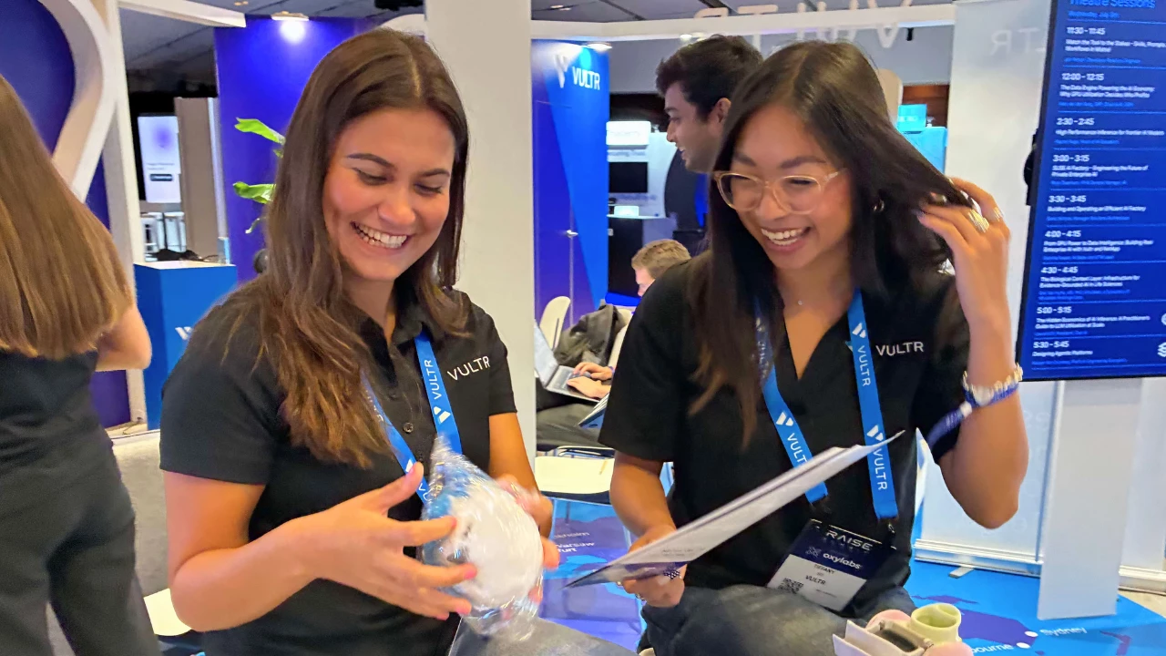 Tiffany So, senior client services manager at Vultr, and Amelie Gaudoin, sales development representative at Vultr, share a laugh at RAISE Summit 2026 in Paris. | Image: DesignRush