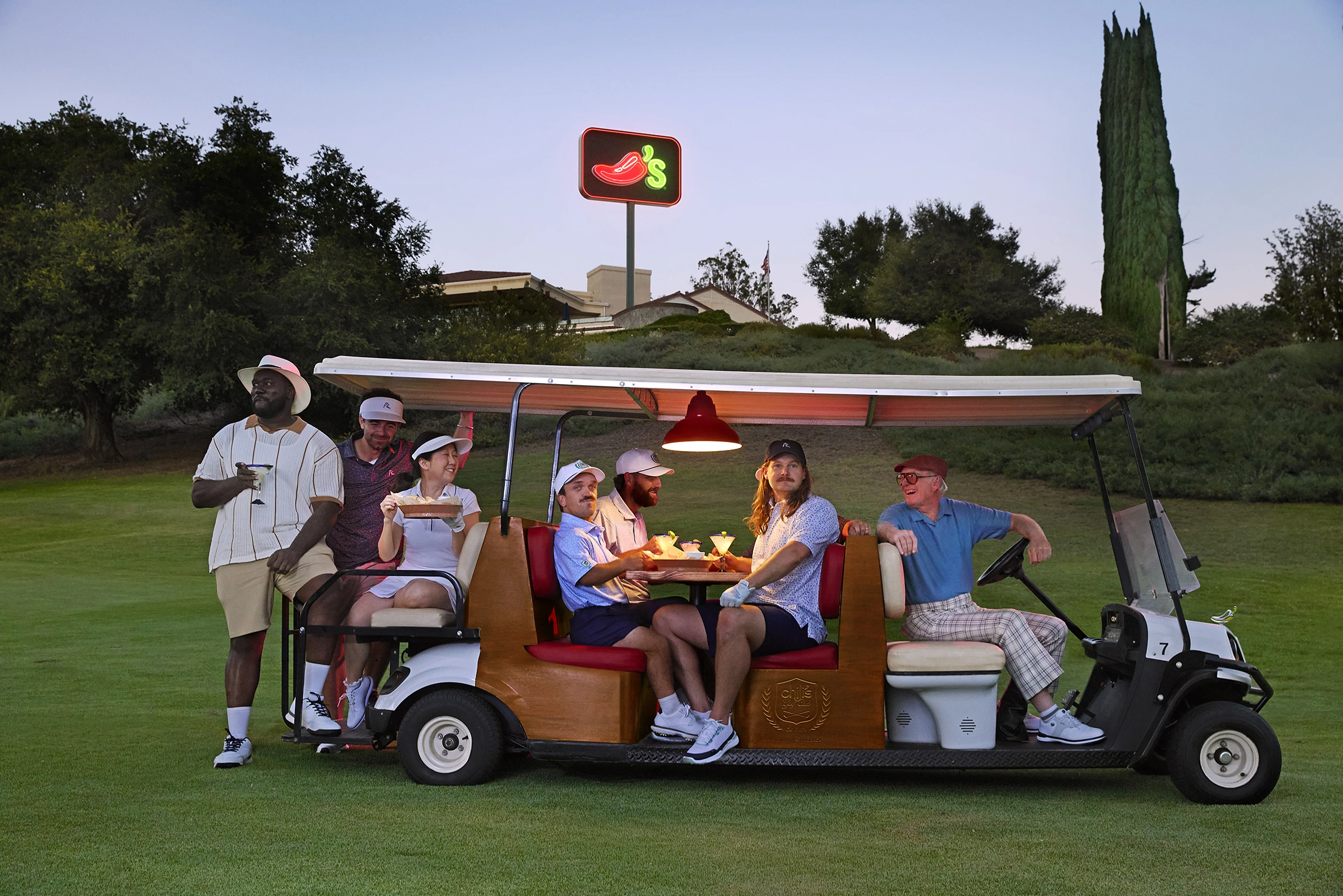 Various golf stars in a course wearing Chili's x Rhoback | Source: Chili's