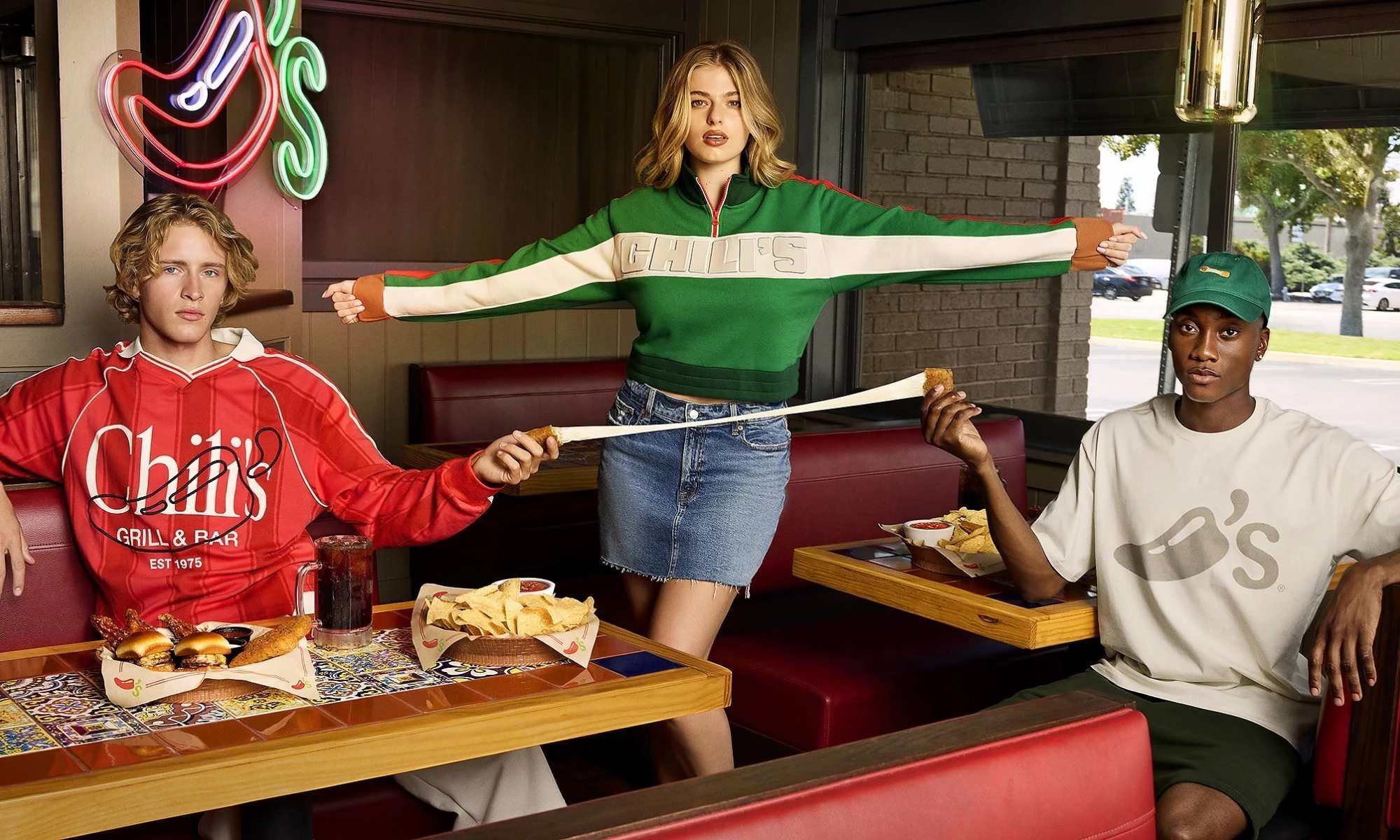 chilis-suburban-collection Chili's quarter-zip Fried Mozz cheese pull with two people deomonstrating the real cheese pull in a restaurant.