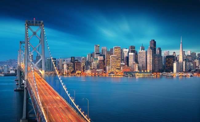 view of San Francisco and the Bay Bridge by night