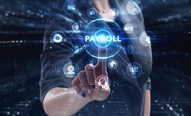 woman working on a virtual screen clickling Payroll button, in a payroll company