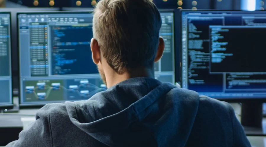 Man facing computers