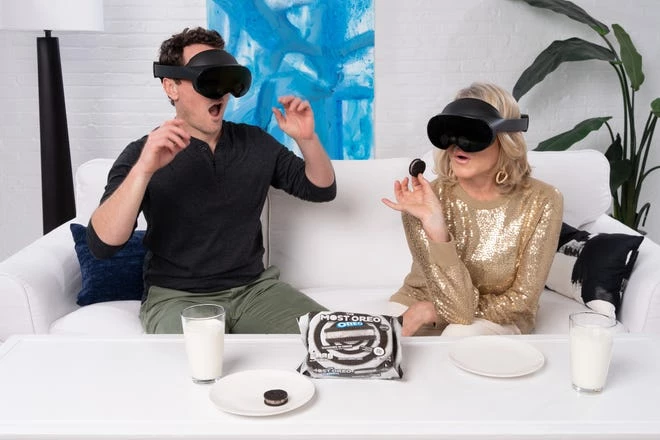 Martha Stewart and Ryan McCallister with VR goggles eating Oreos