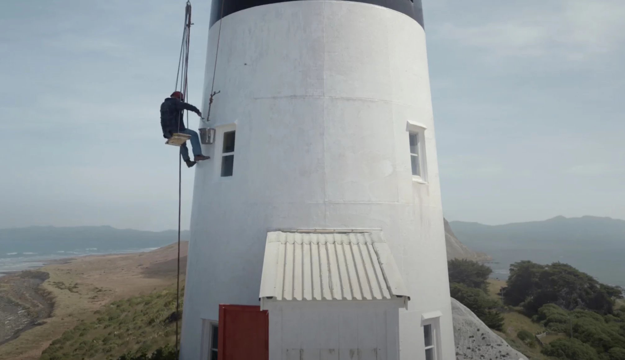 The lighthouse keeper painting the wall.