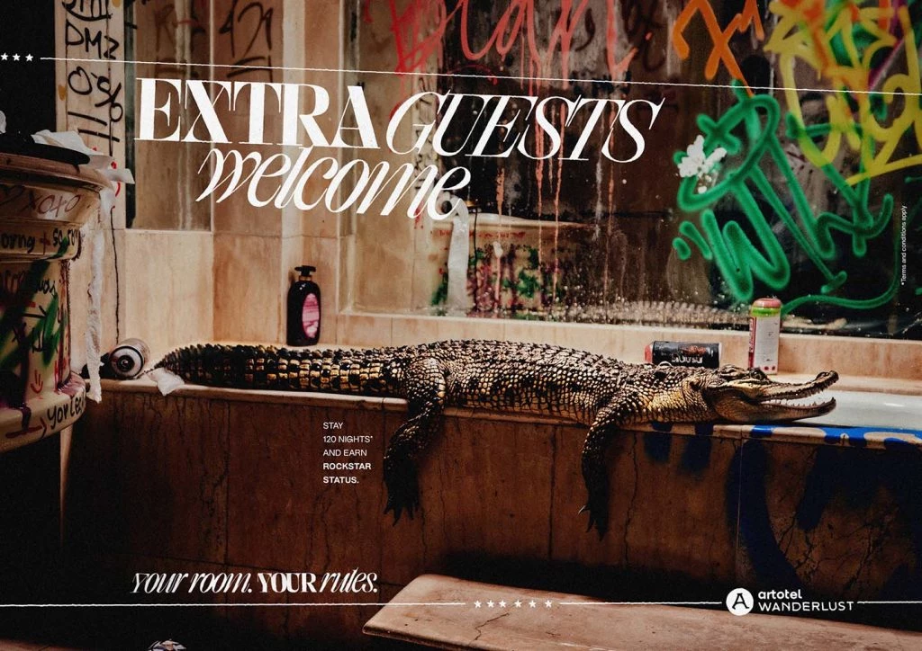 A crocodile lounges on a hotel bathtub.