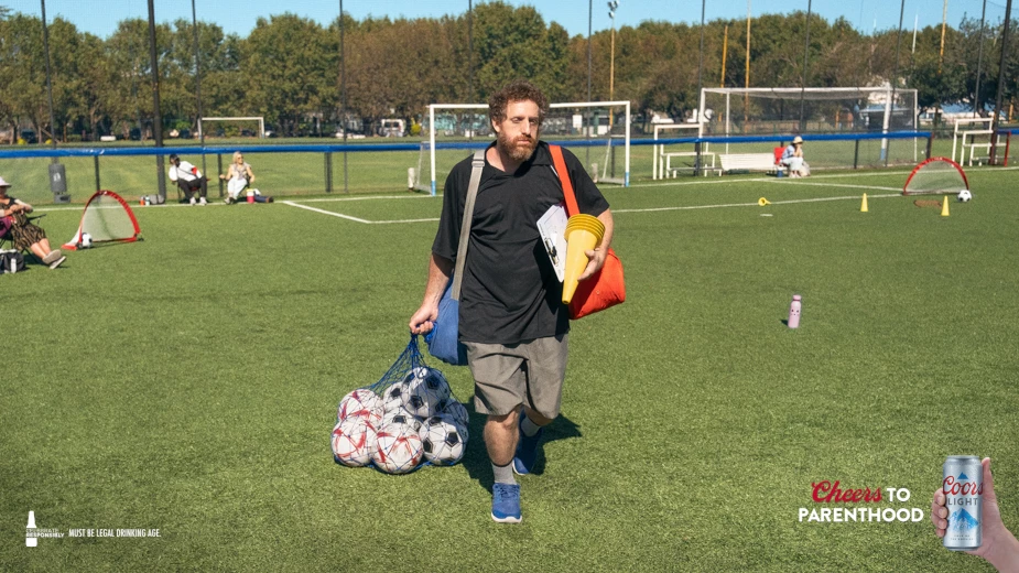 A dad cleans up after a soccer match.