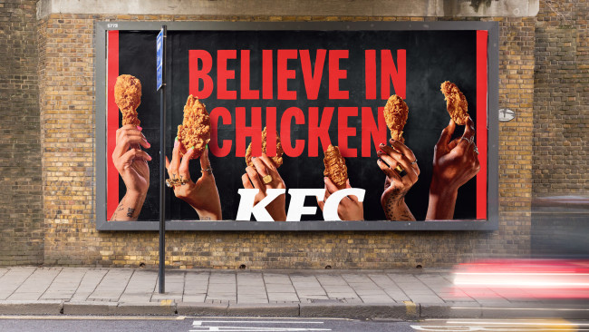 A "Believe in Chicken" OOH ad installed at a high-traffic area.