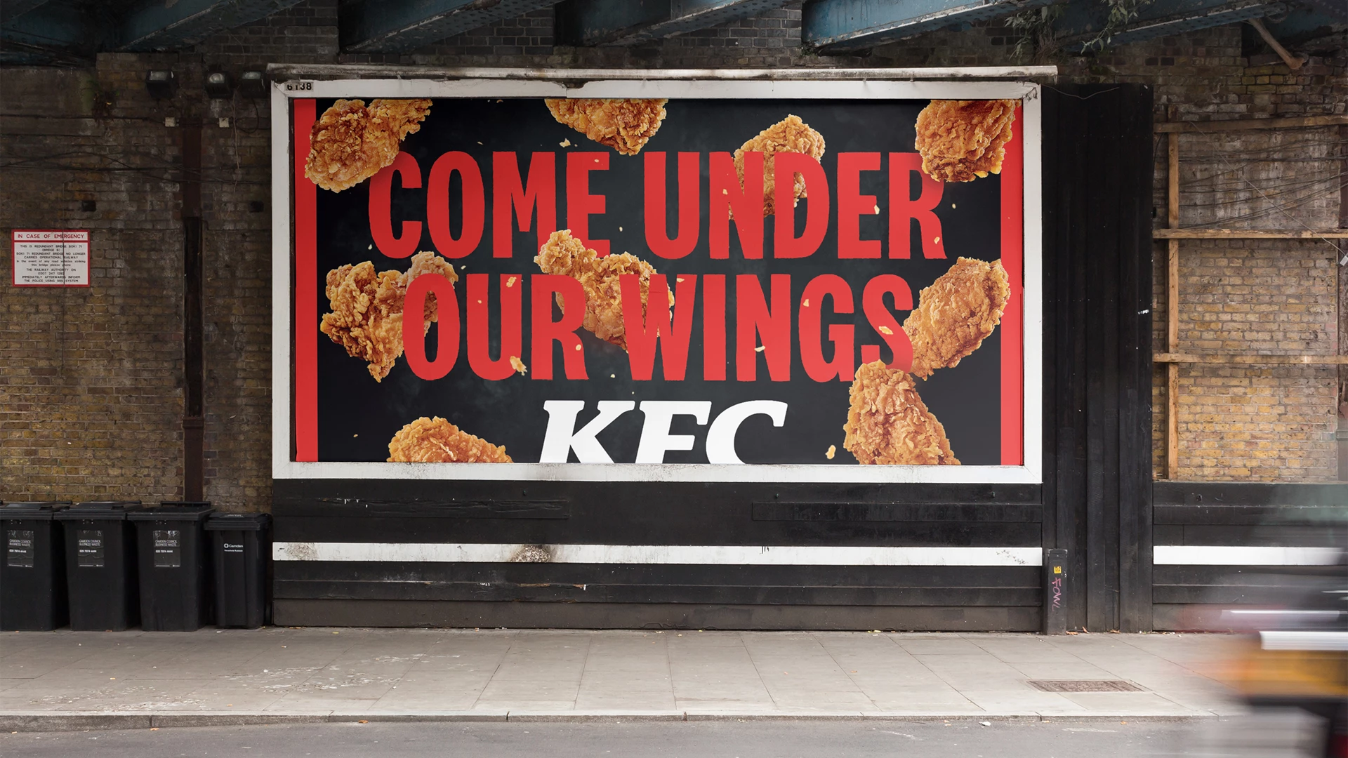 An OOH ad says, "Come under our wings," for KFC's "Believe in Chicken" campaign launch.