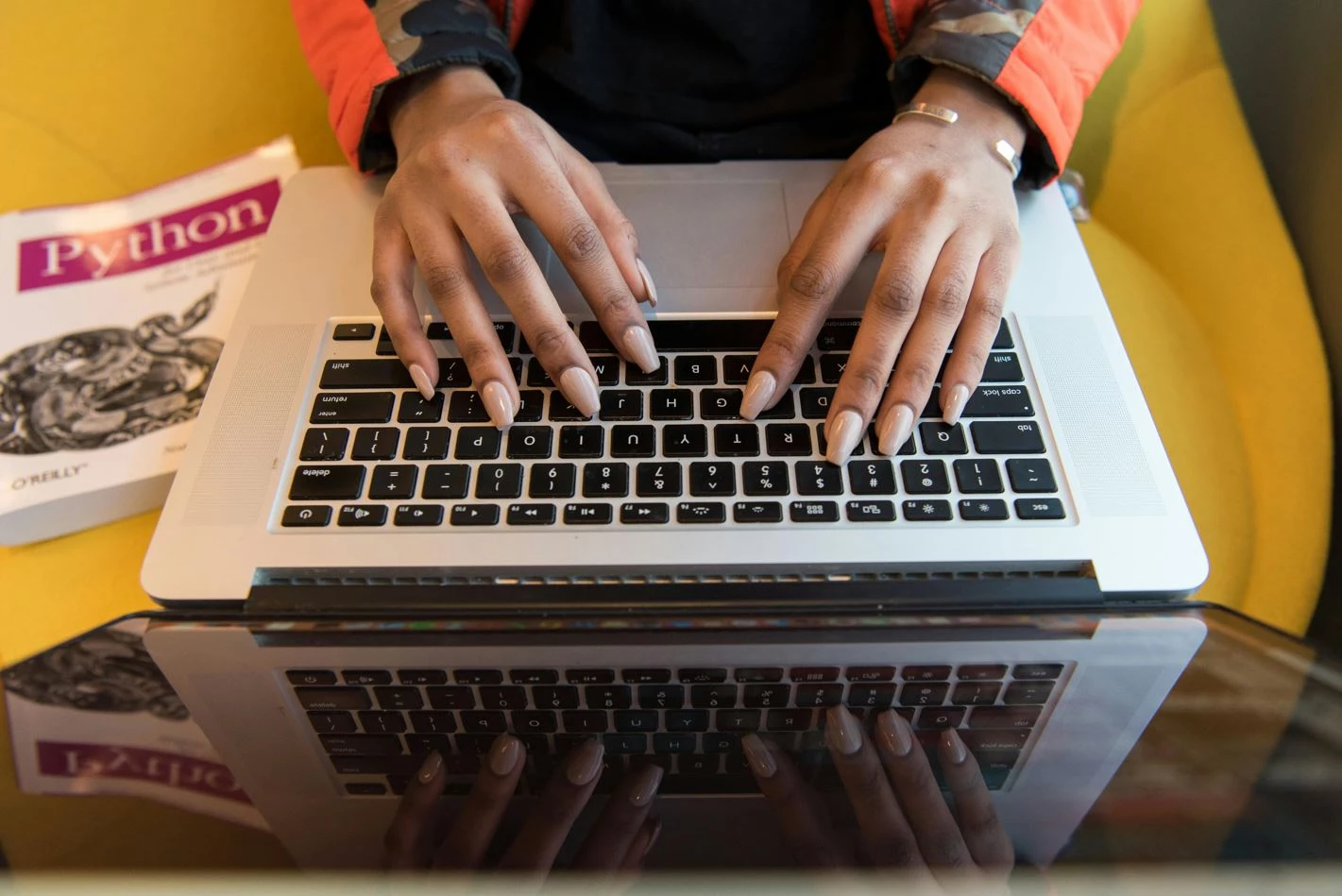 Person typing on laptop, highlighting what is backend development and its benefits