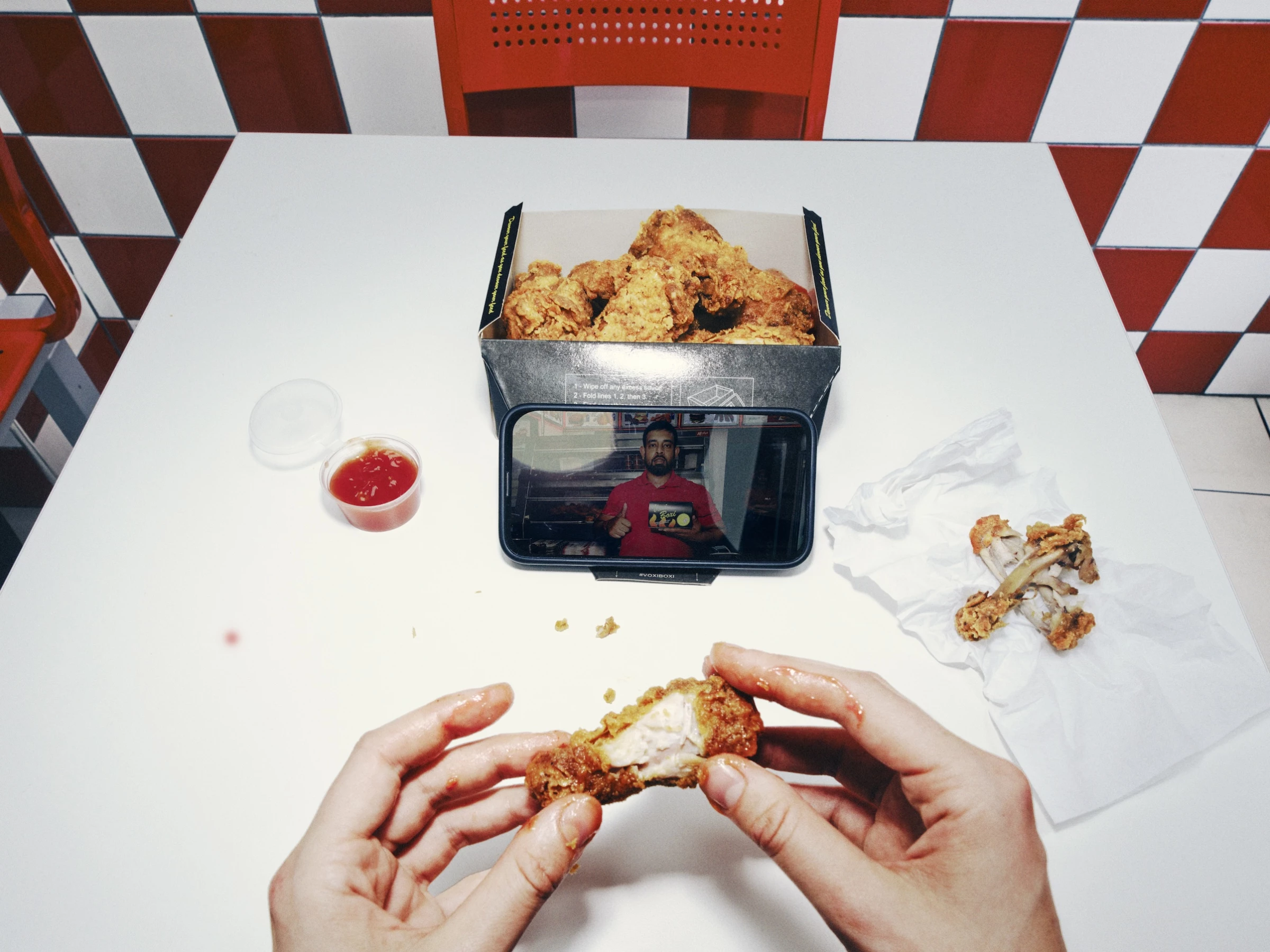 The "Voxi Boxi" chicken box turns the top cover into a cellphone stand.