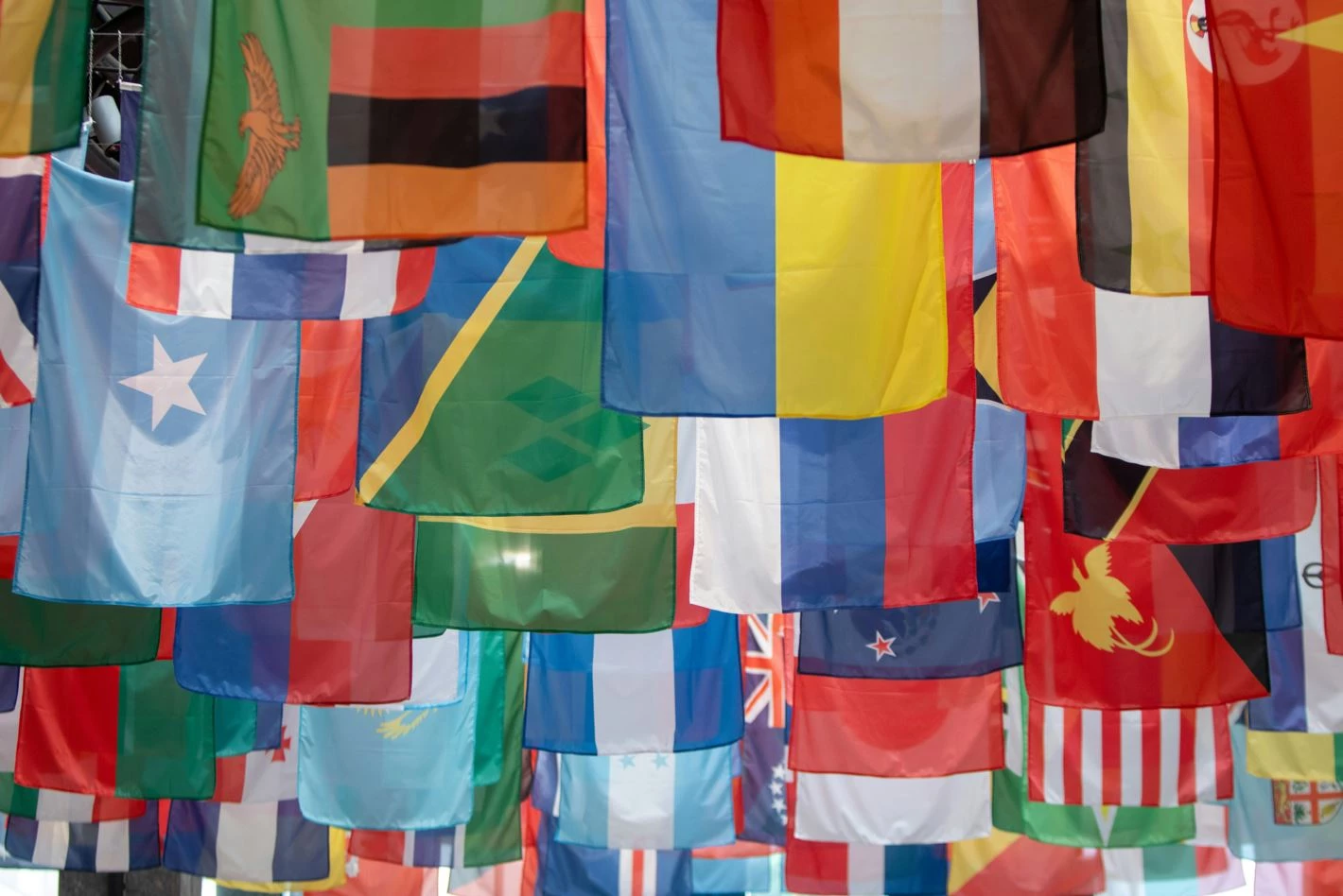 Flags of different countries hung up in bunting across an alleyway, a succinct illustration of the complexities of global branding Flags of different countries hung up in bunting across an alleyway, a succinct illustration of the complexities of global branding
