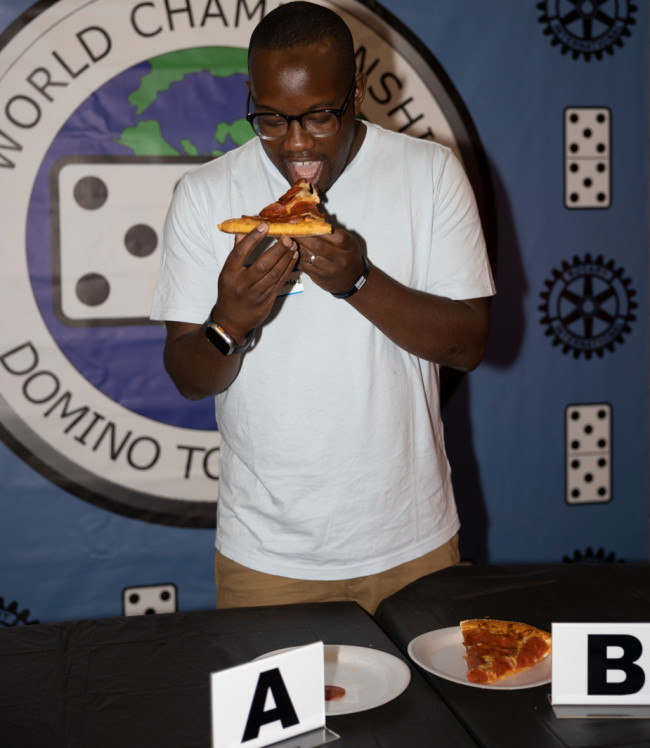 Pizza Hut sponsors domino tournament Man eating Pizza Hut