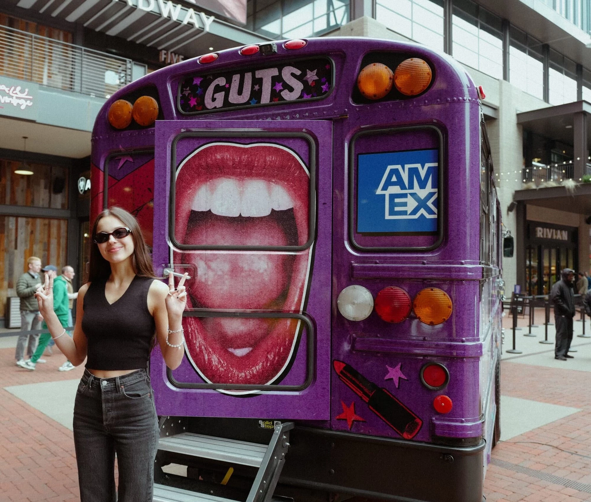 Olivia Rodrigo shows off American Express-branded GUTS World Tour Bus.