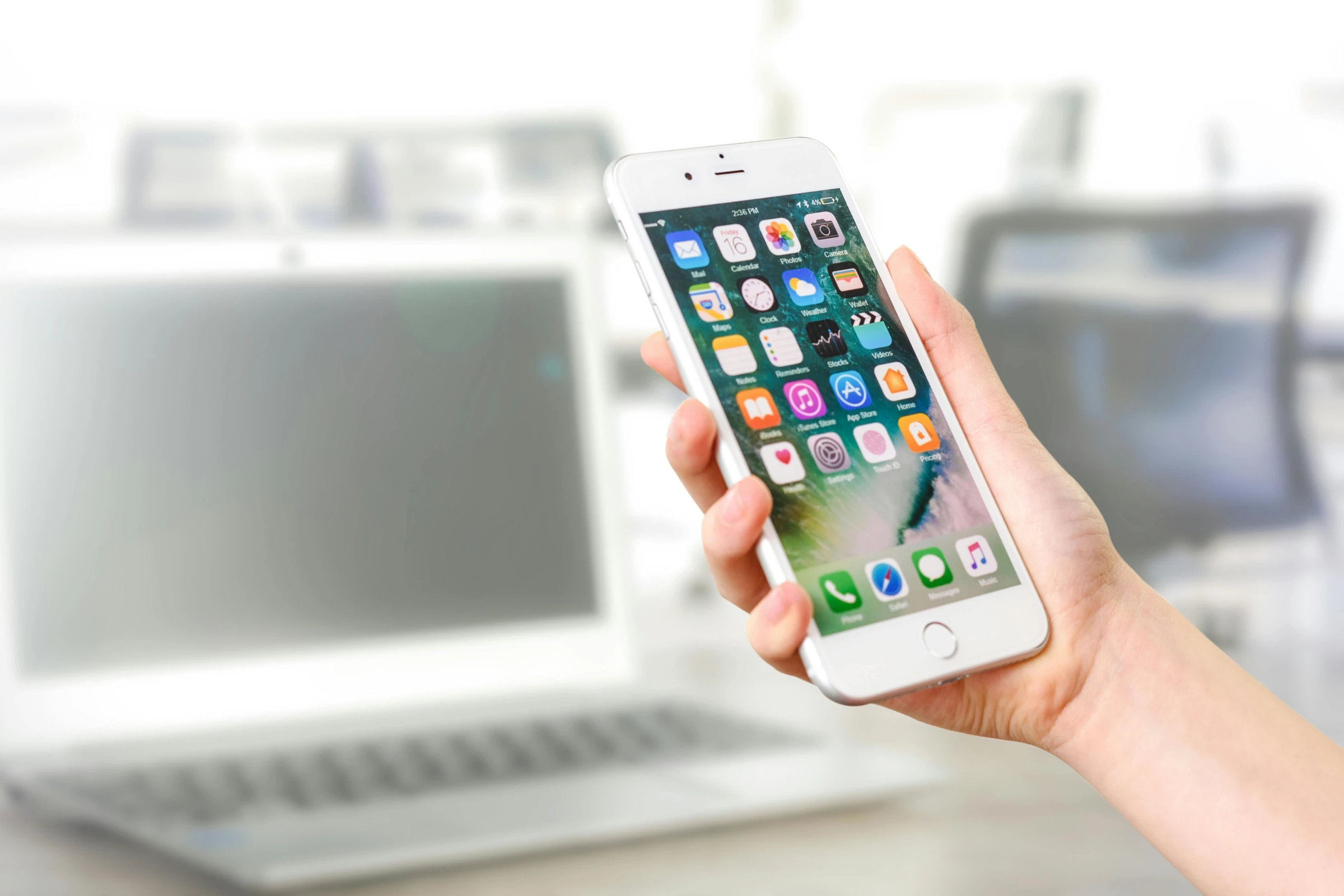 Person holding mobile phone showing apps