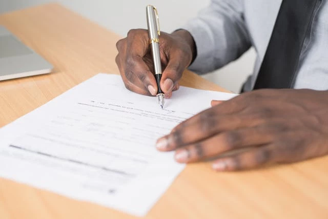 Person writing on a paper