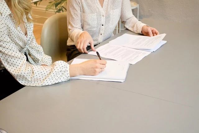 Two women with documents