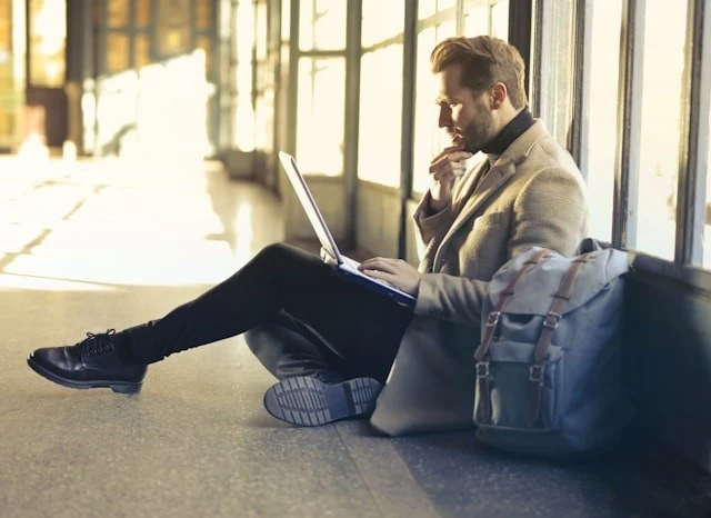 Man sitting on floor with laptop