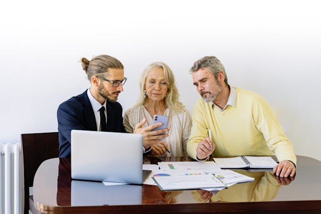 people-at-a-table-looking-at-smartphone People at a table looking at smartphone
