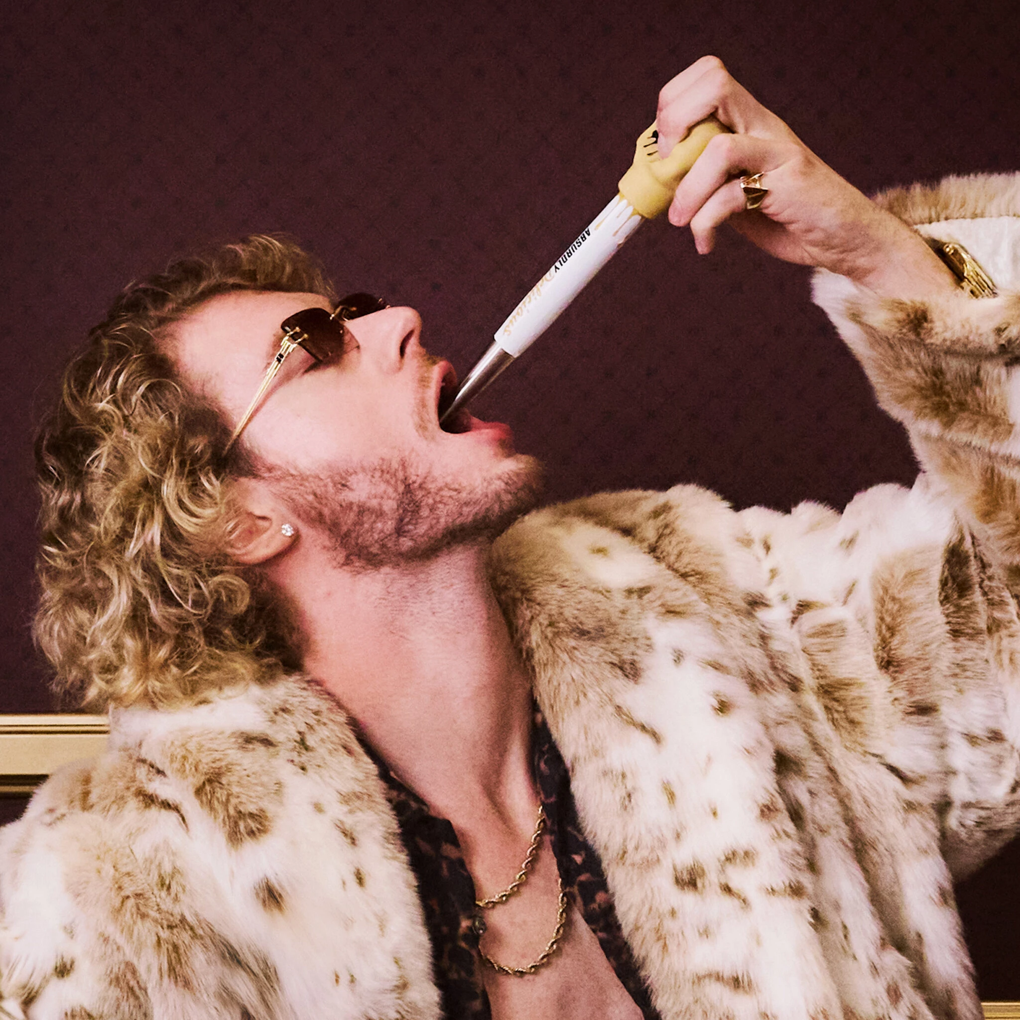 Yung Gravy downing a shot using a Skrewball-branded baster.