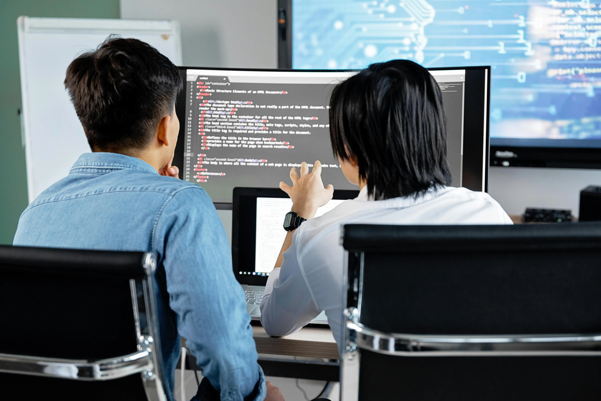 software-developers-discussing-over-computer-display Software developers discussing over computer display